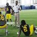 Michigan running back coach Fred Jackson takes a moment to chat with players during media day at the Al Glick Field House on Sunday afternoon. Melanie Maxwell I AnnArbor.com